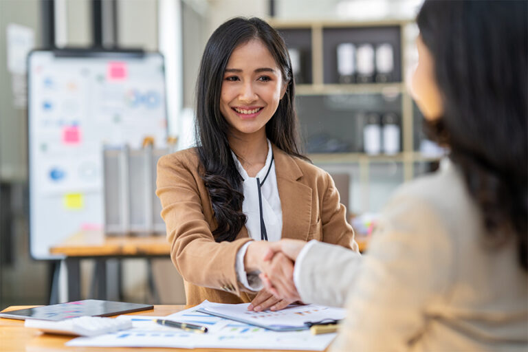 Business-Loan-Malaysia_0001_two-young-asian-businesswomen-shaking-hands-in-a-s-2023-11-27-05-31-20-utc-min